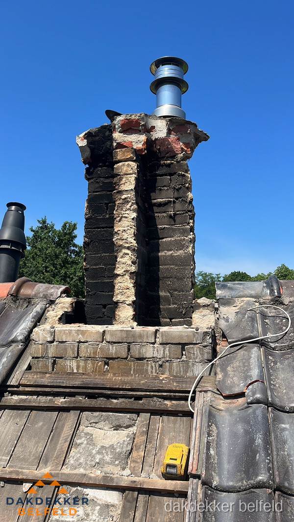 Beschadigde schoorsteen met nieuwe rookgasafvoer op oud dak in Belfeld Beschadigde schoorsteen met nieuwe rookgasafvoer op oud dak in Belfeld